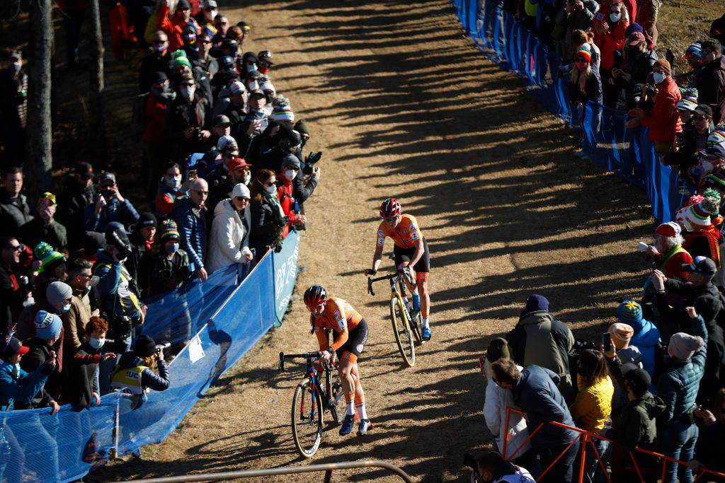 FAYETTEVILLE ARKANSAS JANUARY 29 LR Lucinda Brand of Netherlands and Marianne Vos of Netherlands compete while fans cheer 73rd UCI CycloCross World Championships Fayetteville 2022 Womens Elite Fayetteville2022 on January 29 2022 in Fayetteville Arkansas Photo by Chris GraythenGetty Images