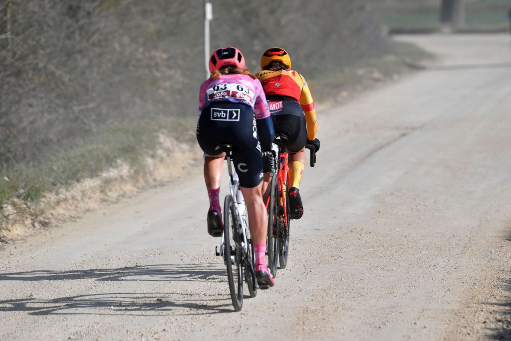SIENA ITALY MARCH 05 LR Emily Newsom of United States and Team EF Education Tibco Svb and Rebecca Koerner of Denmark and UnoX Women Cycling Team compete in the breakaway through gravel roads during the Eroica 8th Strade Bianche 2022 Womens Elite a 136km one day race from Siena to Siena Piazza del Campo 321m StradeBianche on March 05 2022 in Siena Italy Photo by Luc ClaessenGetty Images
