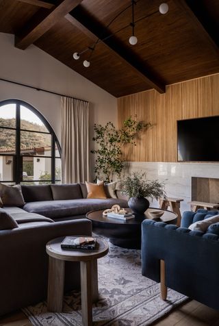 A neutral living room with blue sofas