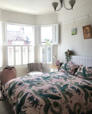 White bedroom and bed with patterned bedding