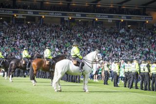 Police patrol the Hampden Park pitch