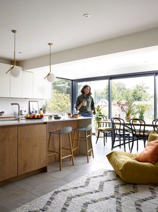 open-plan kitchen diner and living area with wooden cabinets