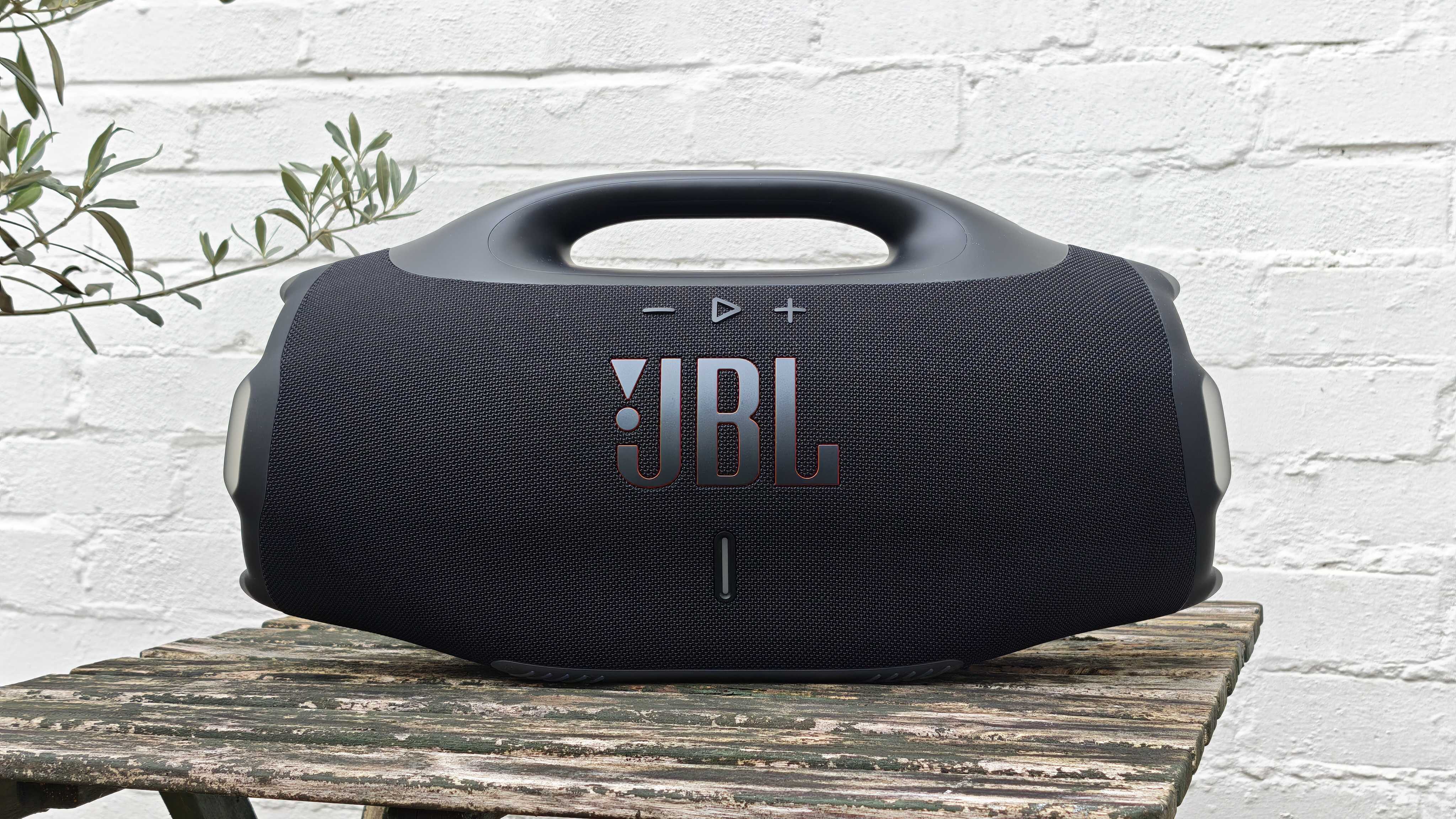 The JBL Boombox 4 on a table outside.