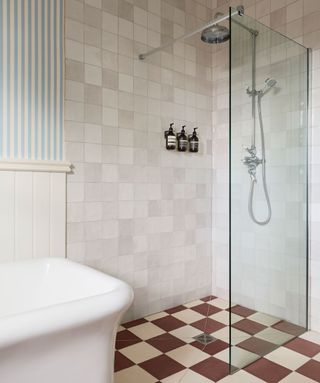 bathroom with tiled walls and glass shower room