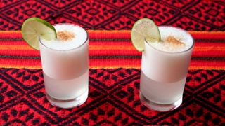 two pisco sour cocktails on a table