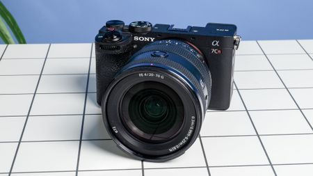 The Sony A7CR on a white table with a blue wall in the background