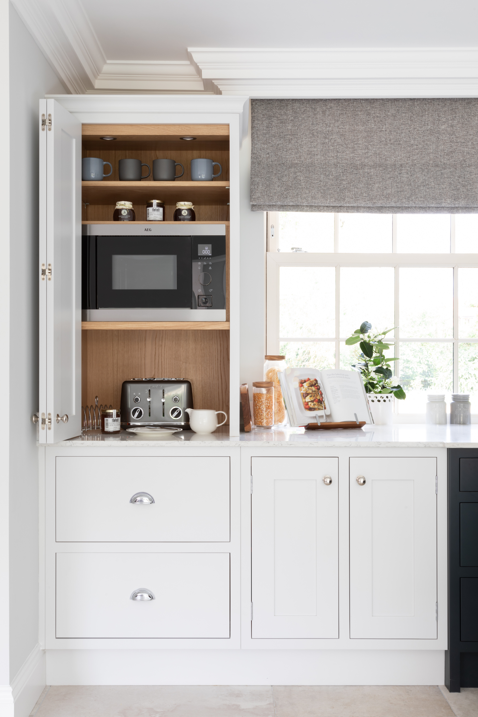 Shaker kitchen with black and white cabinetry and quartz countertops