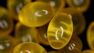 close up of yellow Benzonatate capsules in a pile