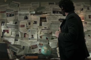 Joe surrounded by newspaper clippings