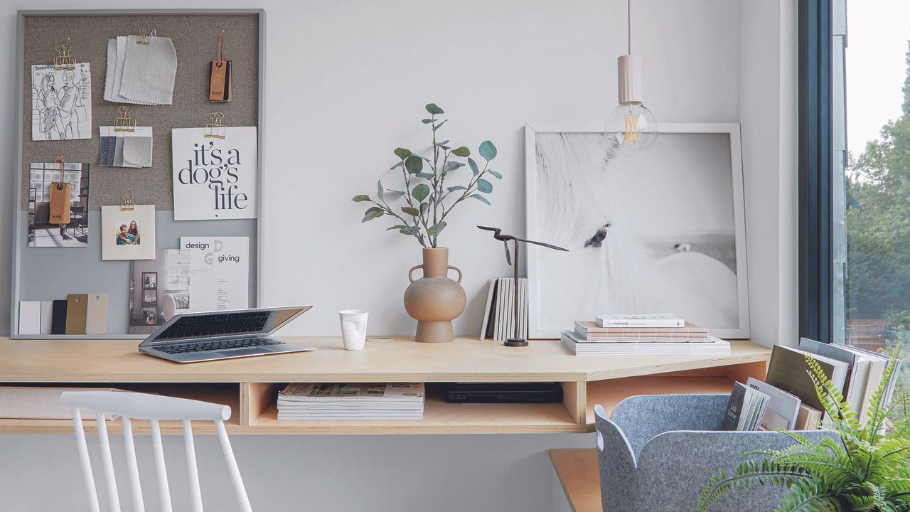 Home office with light oak Scandi desk and hanging bulb.