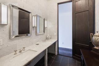 A large bathroom with double marble vanity