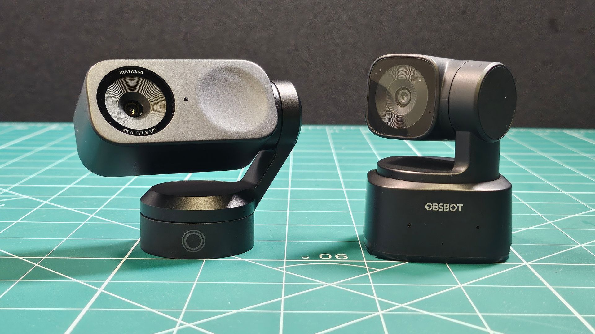 The Insta360 Link 2 next to a similar OBSBOT webcam