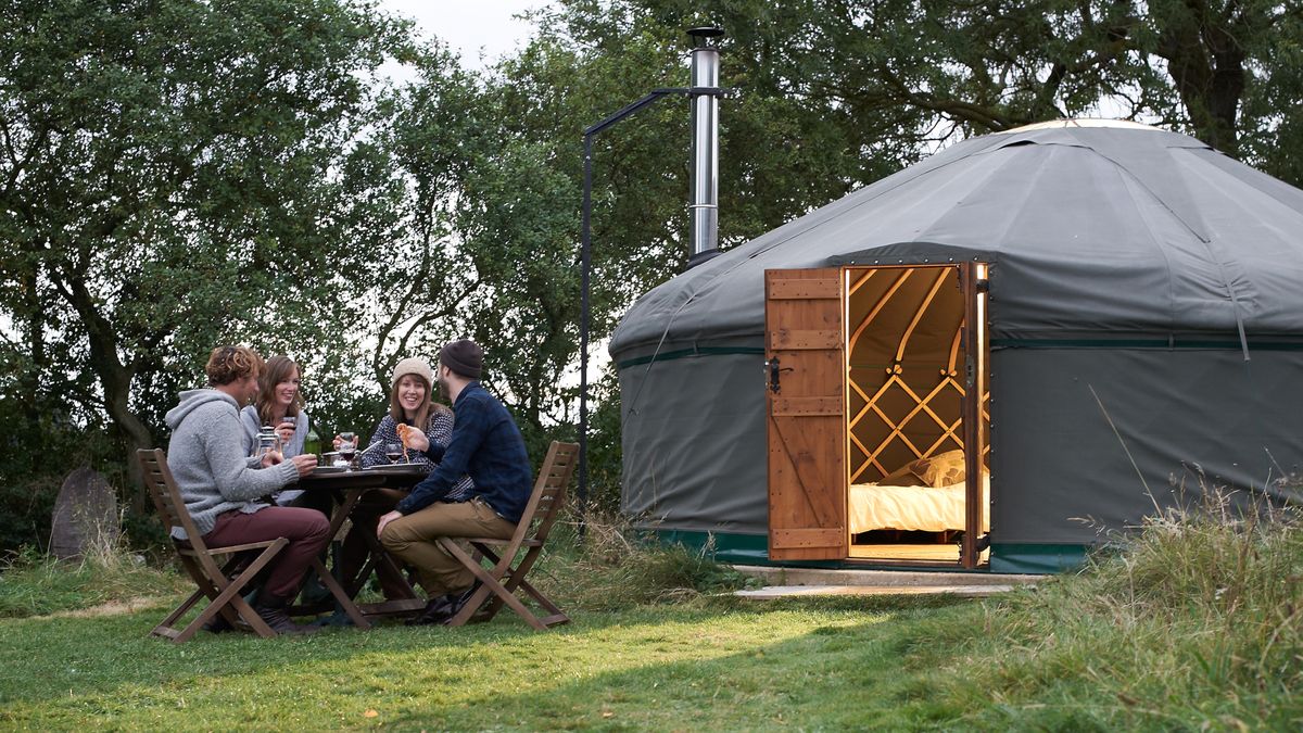 Glampers sitting outside their yurt