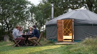 Glampers sitting outside their yurt