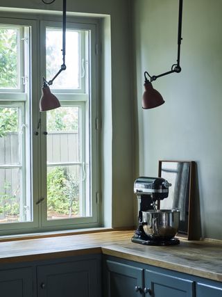 A green kitchen painted in the shade French Gray