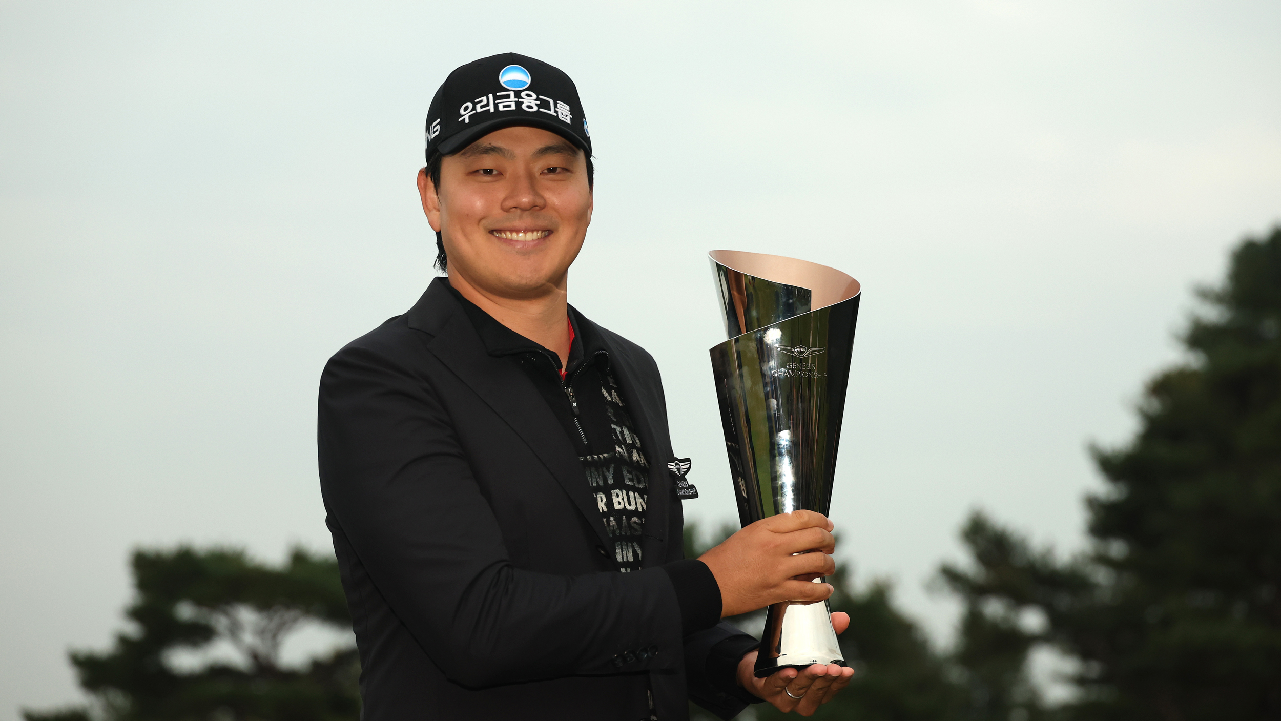Junghwan Lee poses with the Genesis Championship trophy after winning in 2025