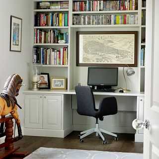 home office room with wooden flooring and white shelves