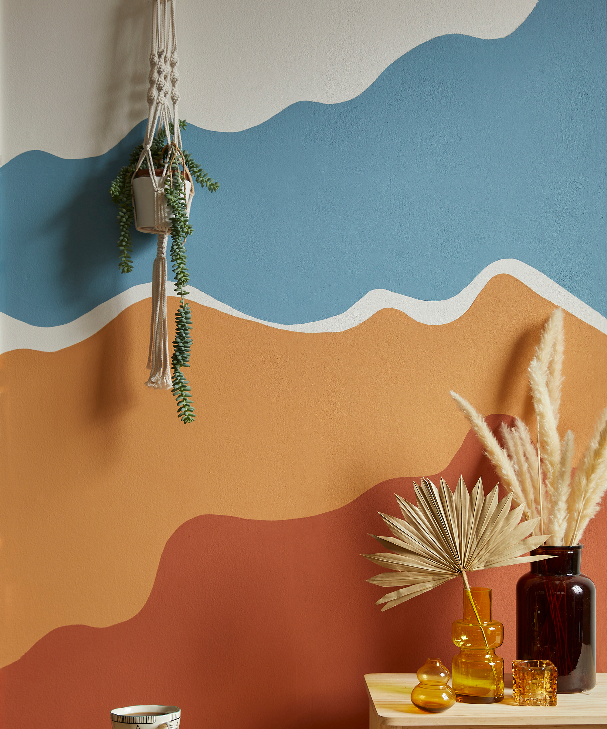 wall painted with wavy pattern in blue and oranges