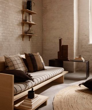 A living room corner idea by Nest using Fern Living Kona Bed, exposed brick walls and modular shelf
