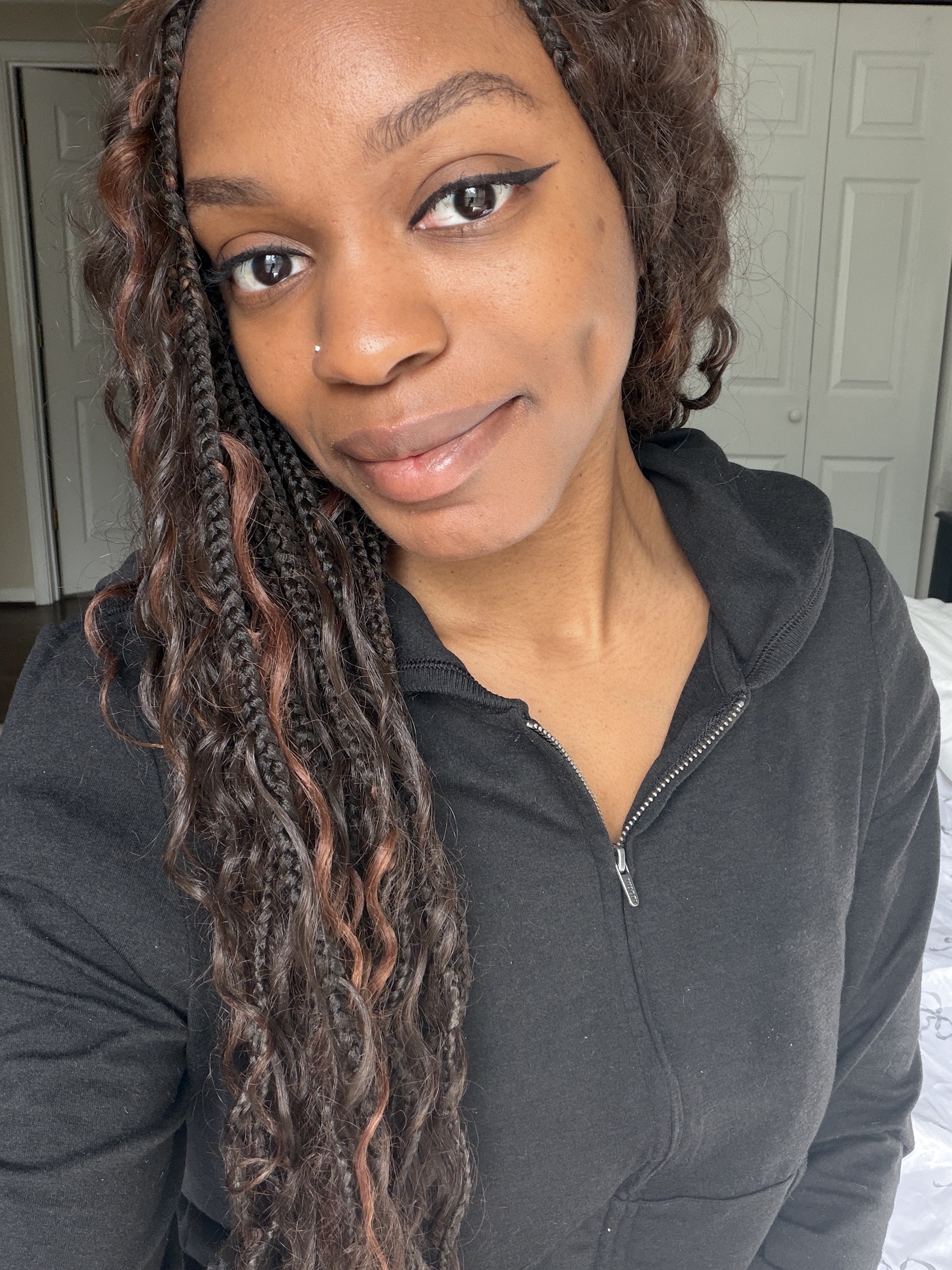 an after photo of a woman testing a black liquid eyeliner