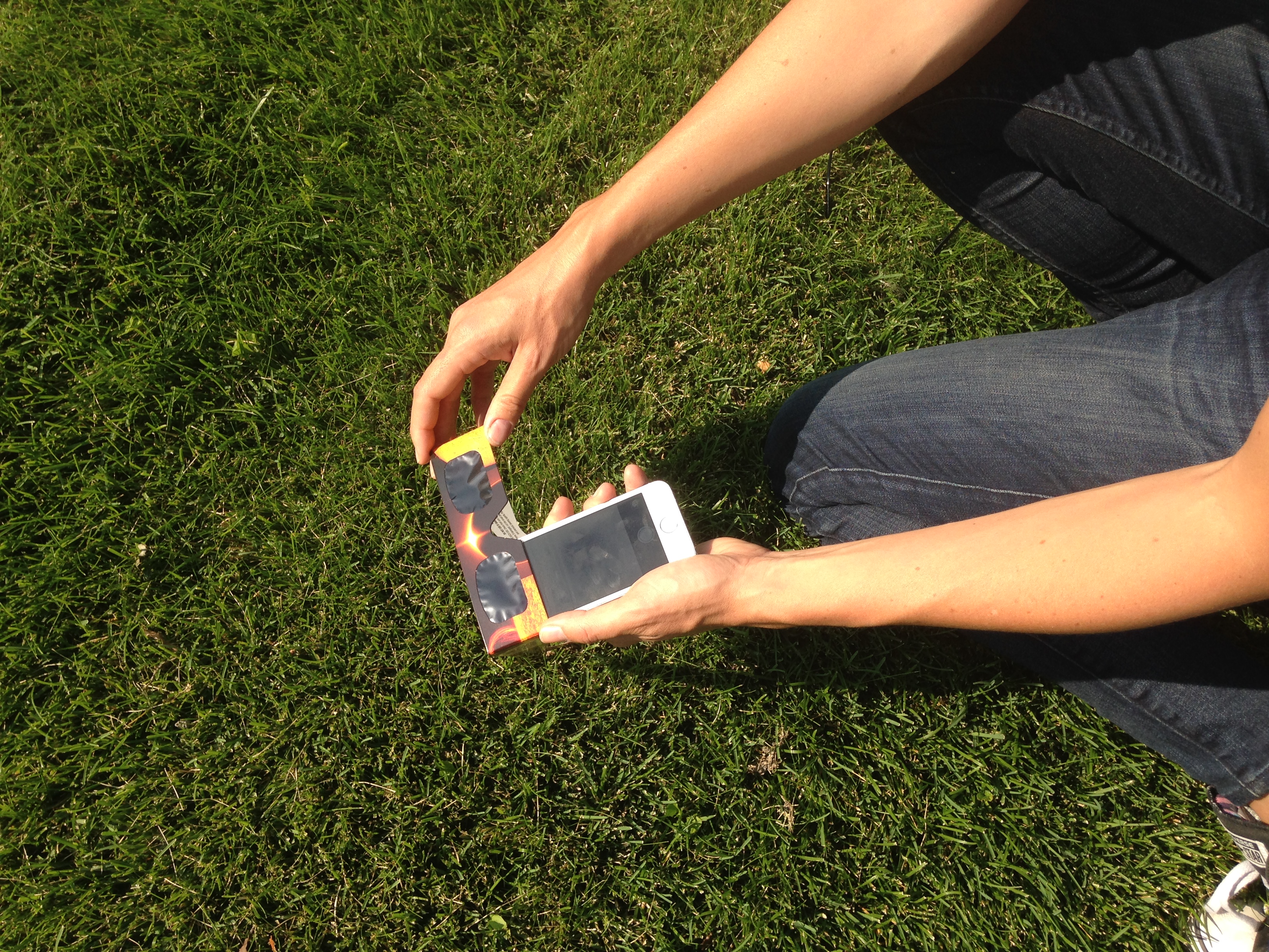 To protect your eyes and your device, photograph the sun using a solar filter, and use the front-facing camera so you can look down at the screen.