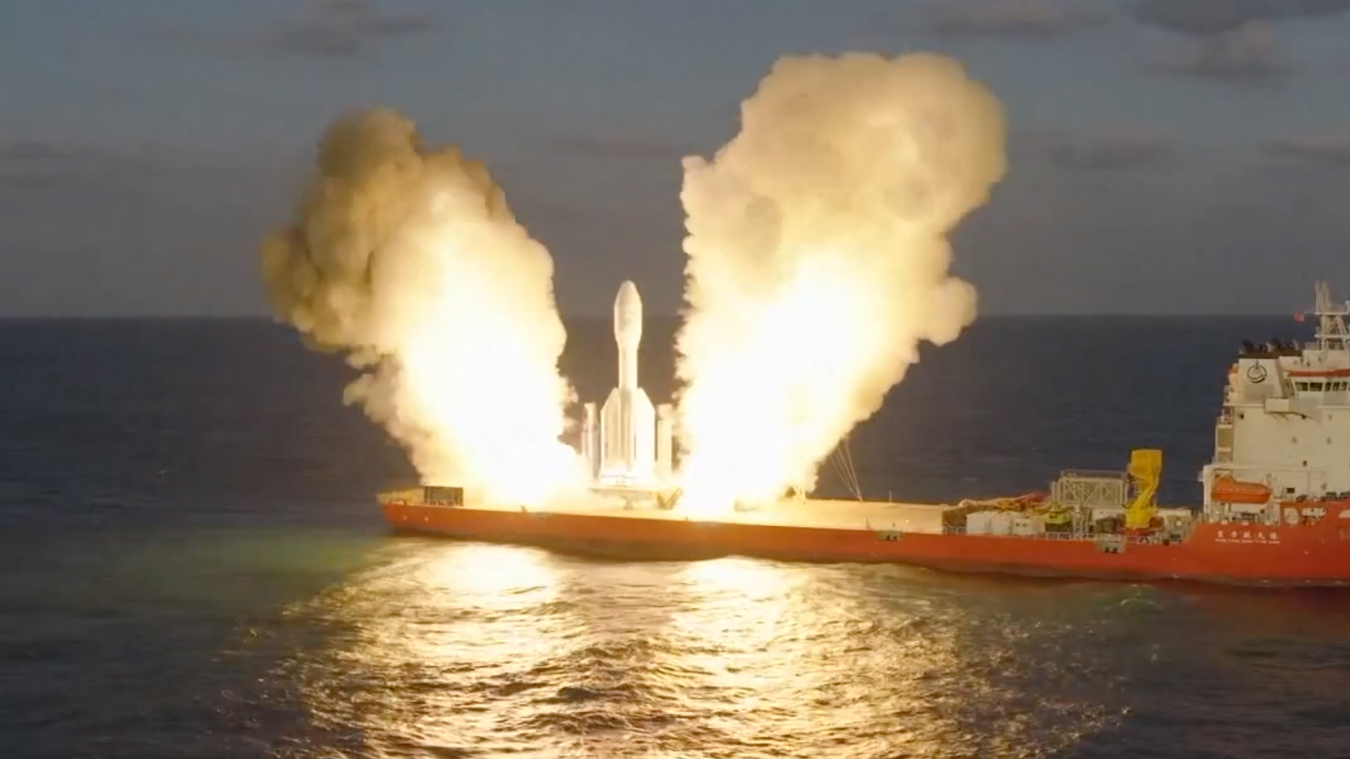 a short, stubby white rocket launches from a ship at sea