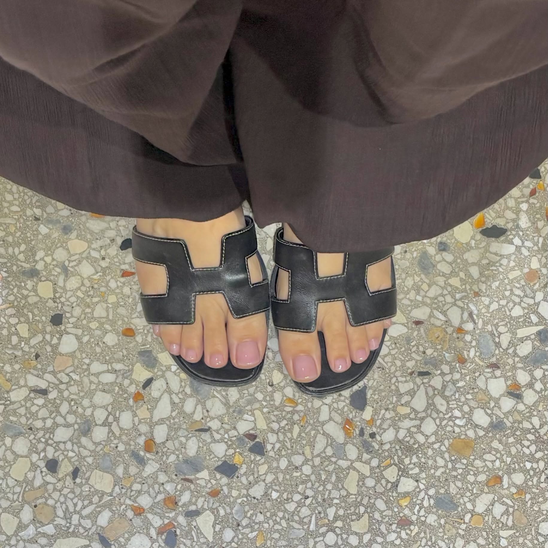 Muted mauve pedicure styled with open-toe Herm&amp;egrave;s sandals for a summer look
