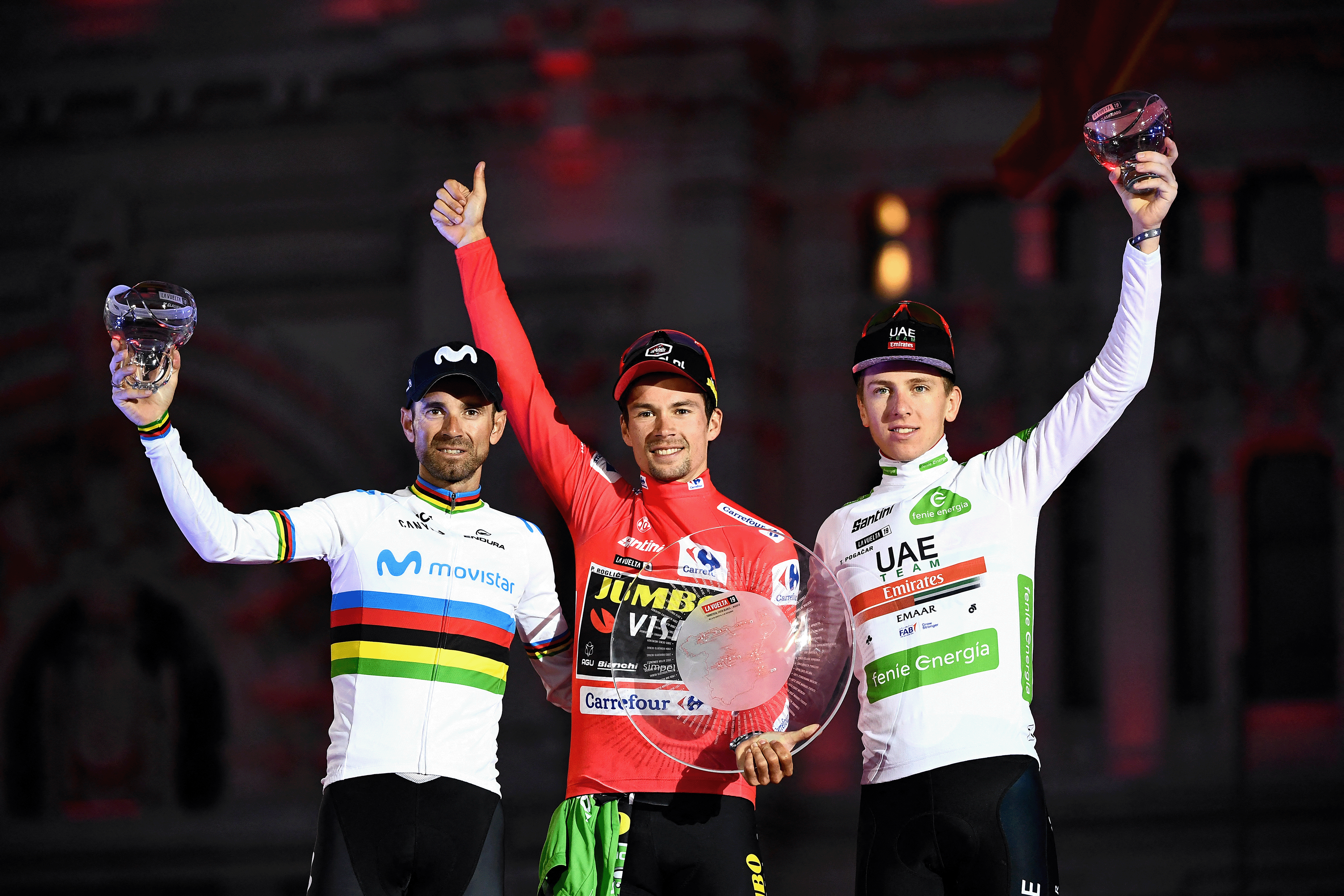 Second-placed Alejandro Valverde, winner Primoz Roglic and third-placed Tadej Pogacar celebrate on the podium after the 21st stage of the 2019 La Vuelta (Photo by OSCAR DEL POZO/AFP via Getty Images)