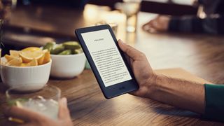 Amazon Kindle ereader being held in a man's hand