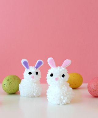 Cute DIY pom pom bunnies idea with colored eggs.