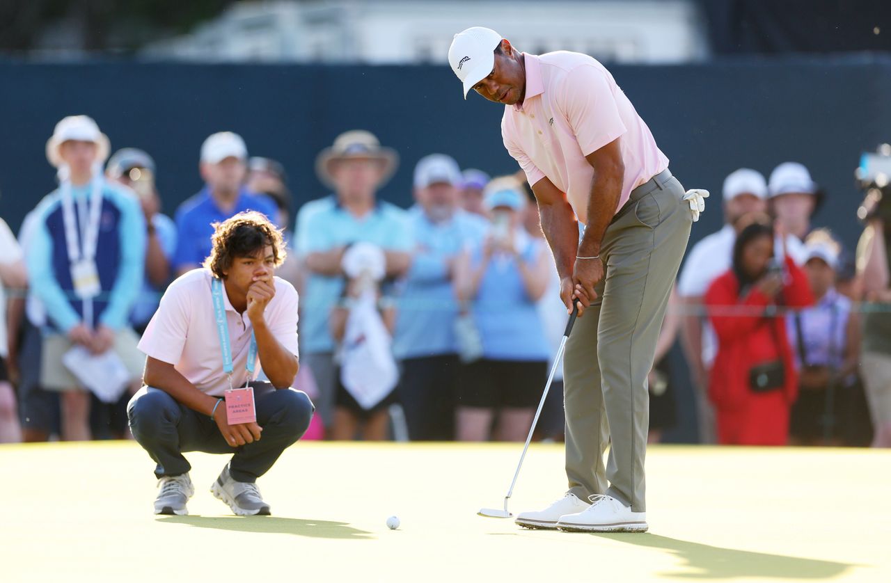 Charlie Woods and Tiger Woods on the green before the US Open