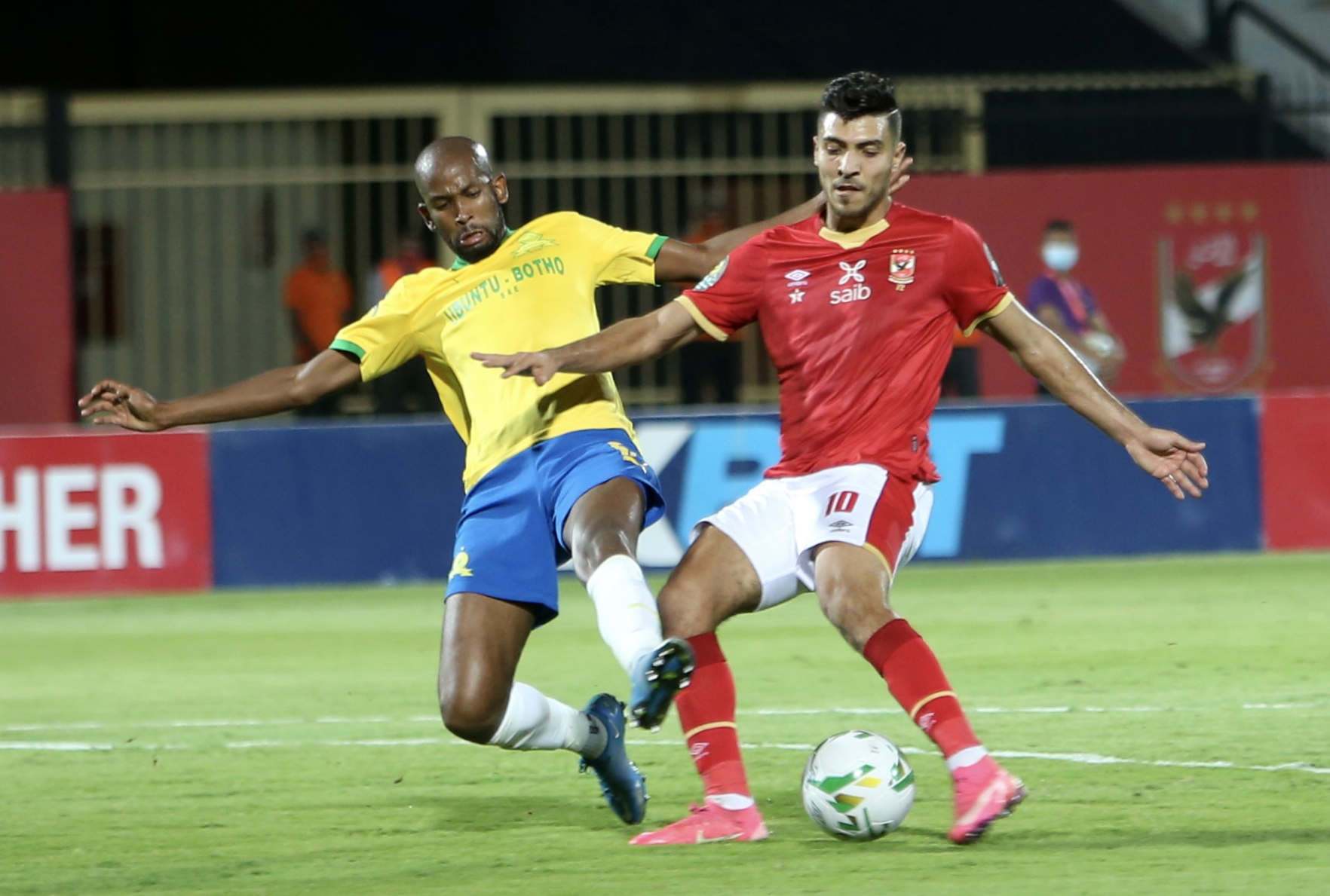 Mohamed Sherif of Al Ahly challenged by Mosa Lebusa of Mamelodi Sundowns