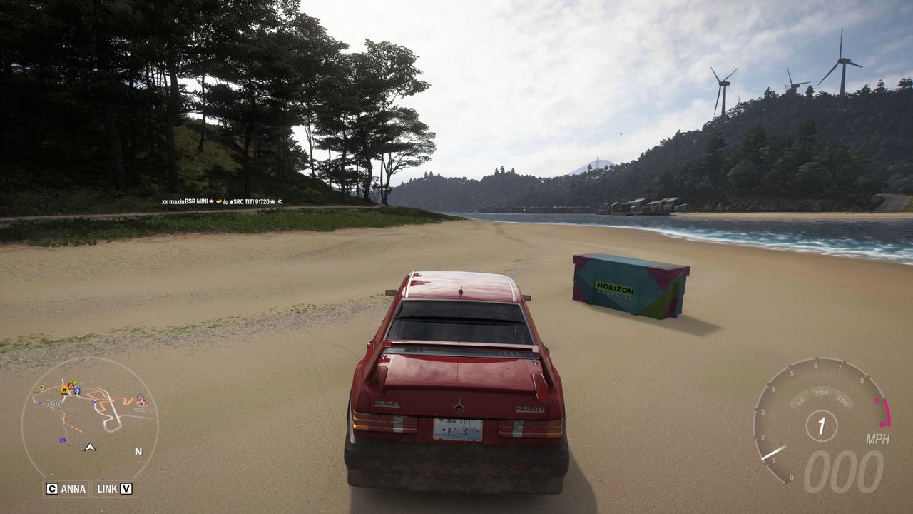 Forza Horizon 6 Ito Treasure Hunt: A red car parked on a beach next to a colourful treasure chest.