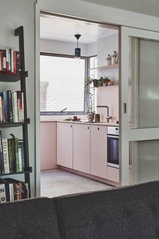 Pink mid-century kitchen inside a n apartment