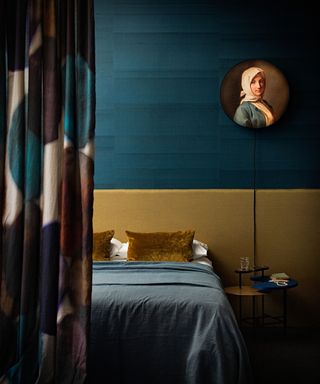 Blue and yellow ochre bedroom, silk wall coverings, bed, blue bedspread, period painting
