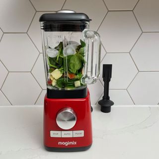 Magimix power blender jug containing ice and spinach