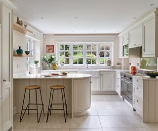 cream Shaker kitchen with curved kitchen island and large format floor tiles