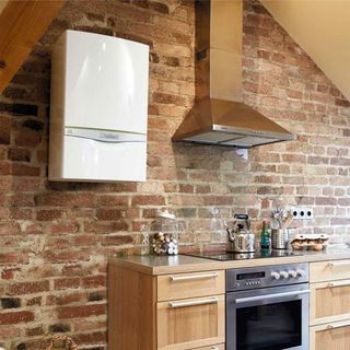 kitchen with white boiler on exposed brick wall