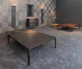 Small designer cot with dark flooring.