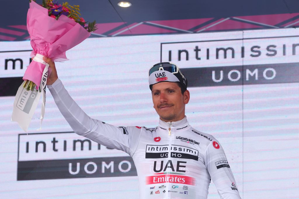 UAE Team Emiratess Portuguese rider Joao Almeida celebrates his best young riders white jersey on the podium after the nineteenth stage of the Giro dItalia 2023 cycling race 183 km between Longarone and Tre Cime di Lavaredo rifugio Auronzo on May 26 2023 Photo by Luca Bettini AFP Photo by LUCA BETTINIAFP via Getty Images