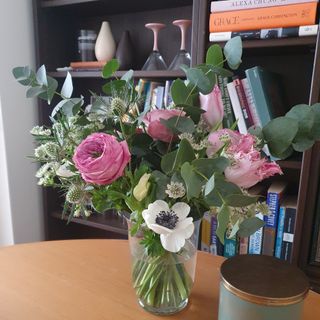 A flower bouquet on a dining table with the M&S peony roses, anemones, parrot tulips and eucalyptus