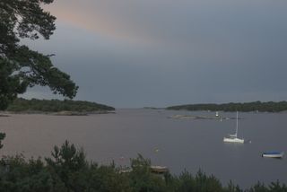 View of sunset over sea from a Swedish traditional summer home on an island