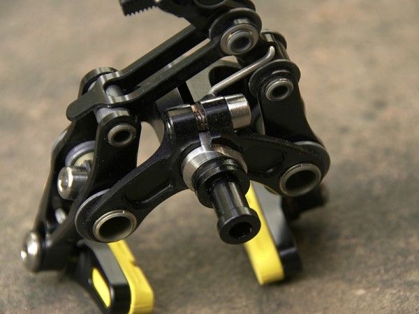 The eccentric mounting stub adds to the overall caliper rigidity in theory but complicates installation.