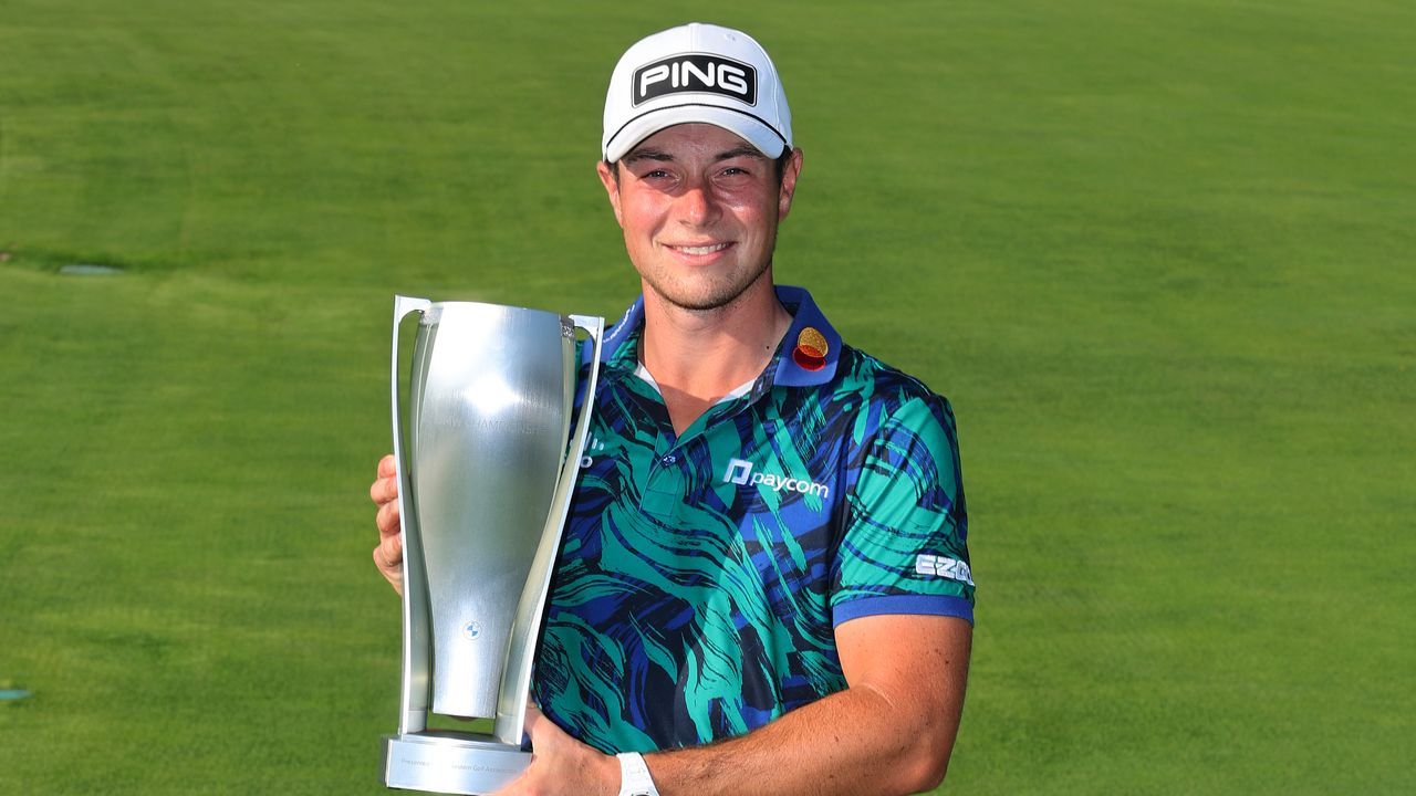 Viktor Hovland poses for a photo with the BMW Championship trophy