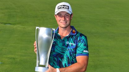 Viktor Hovland poses for a photo with the BMW Championship trophy