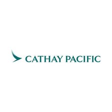 A Cathay Pacific plane flying over the top of a city