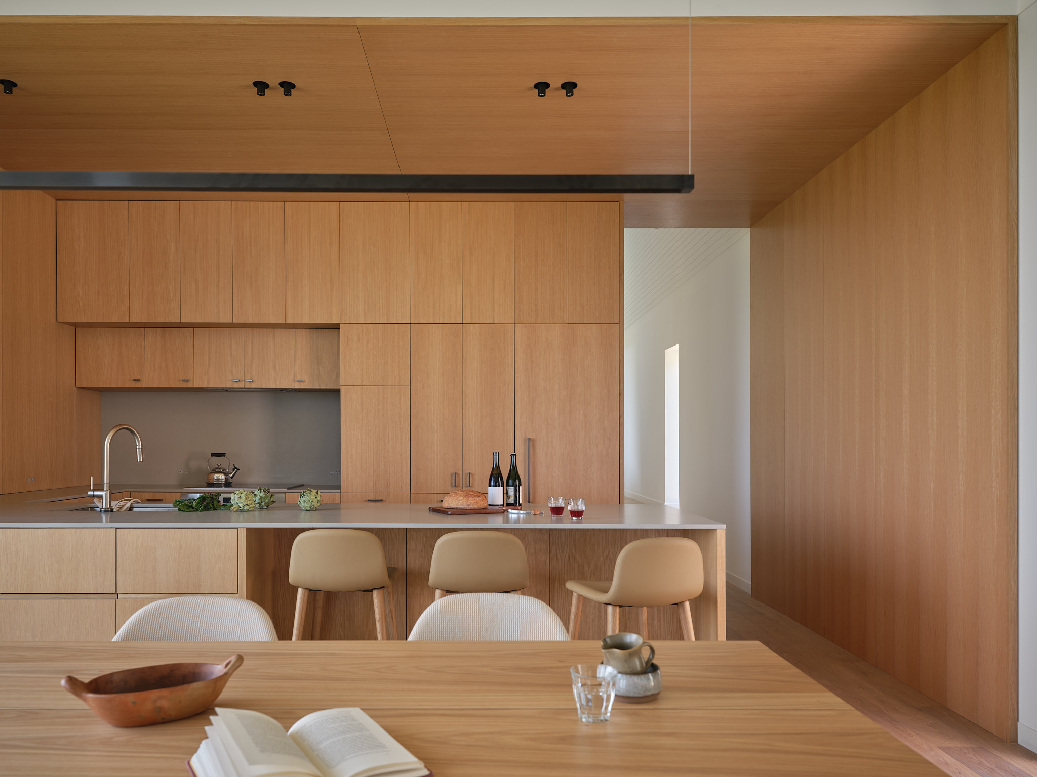 place of work's house in a meadow between the forest and the sea, an architectural, geometric house in leafy countryside