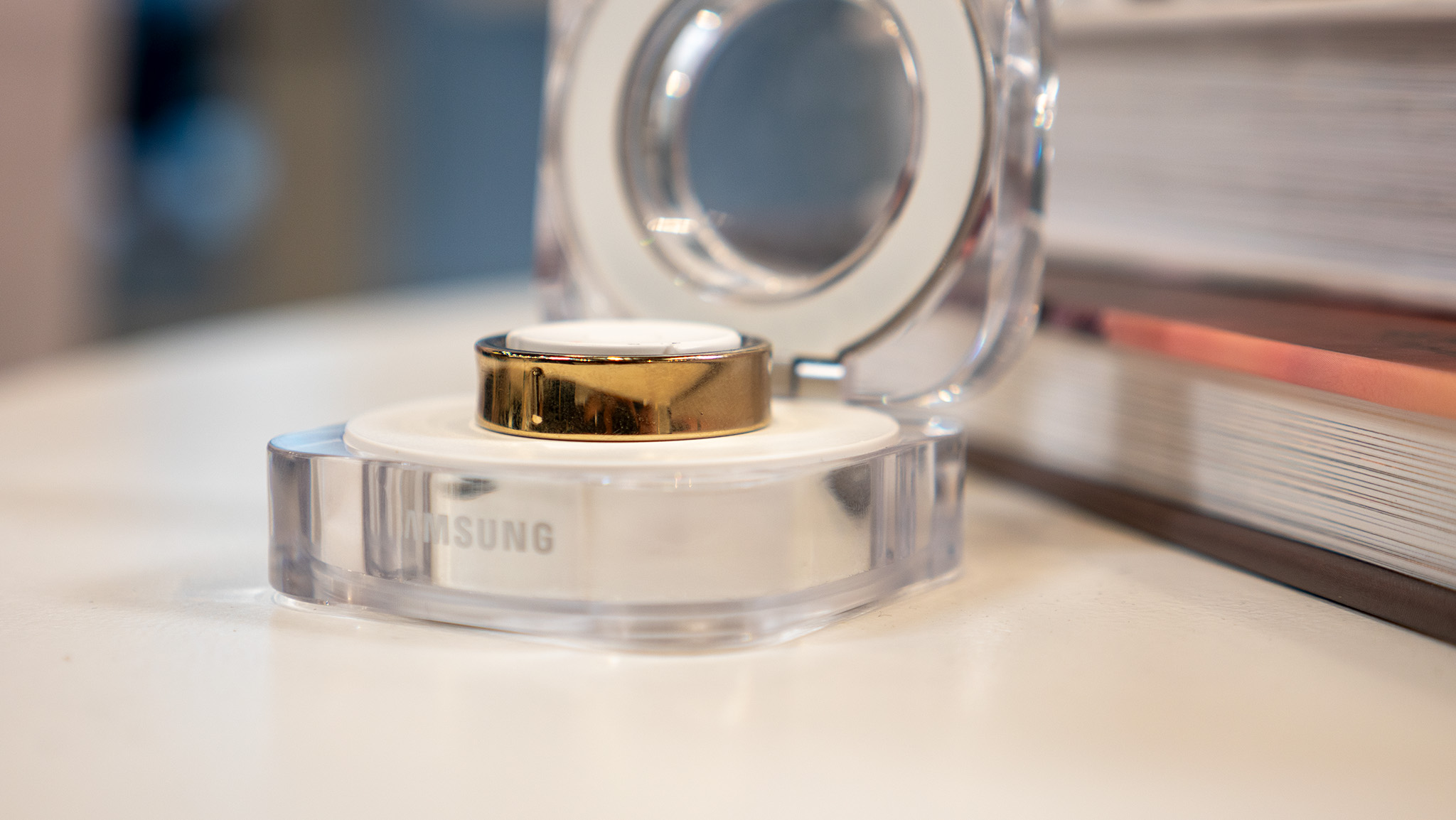 The gold Galaxy Ring in the charging cradle