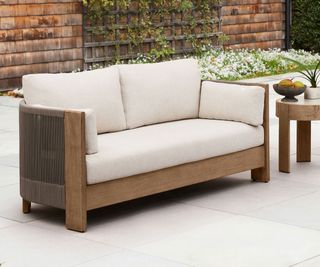 wood and upholstered outdoor sofa on a patio
