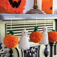 orange coloured hanging pom ball and white halloween 